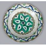 A 16TH / 17TH CENTURY OTTOMAN IZNIK POTTERY DISH, with polychrome decoration, 20cm diameter.