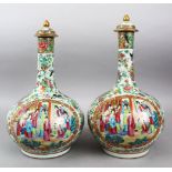 A GOOD PAIR OF 19TH CENTURY CHINESE CANTON FAMILLE ROSE PORCELAIN BOTTLE VASES & COVERS, the body of