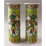 A PAIR OF 19TH CENTURY FAMILLE VERTE PORCELAIN CYLINDRICAL VASES, each depicting two paneled