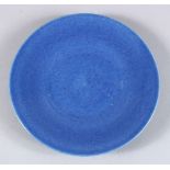 A 19TH CENTURY CHINESE POWDER BLUE MONOCHROME PORCELAIN DISH, 22.5cm diameter.