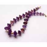 AN AMETHYST AND PEARL NECKLACE, comprising twenty seven facet cut amethysts, interspersed with