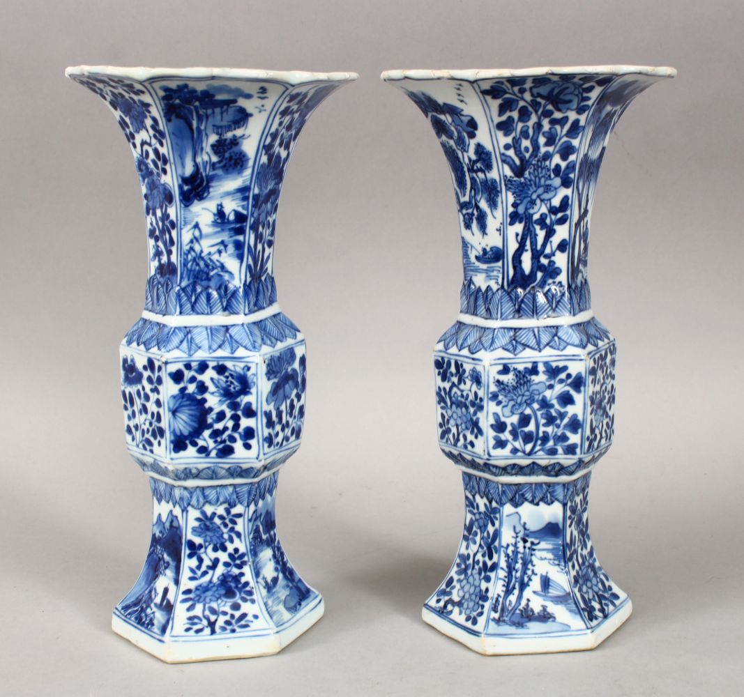 A GOOD PAIR OF 18TH CENTURY CHINESE KANGXI BLUE & WHITE GU SHAPE PORCELAIN VASES, with a multitude