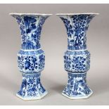 A GOOD PAIR OF 18TH CENTURY CHINESE KANGXI BLUE & WHITE GU SHAPE PORCELAIN VASES, with a multitude