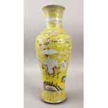 A 19TH CENTURY CHINESE FAMILLE ROSE YELLOW GROUND YIN PING SHAPED PORCELAIN VASE, decorated with
