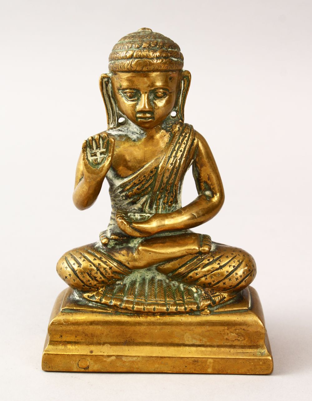 A 20TH CENTURY BRONZE FIGURE OF BUDDHA, in a seated meditating position, 13.5cm high x 9cm.