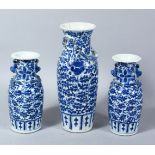 A GOOD 19TH CENTURY GARNITURE OF THREE CHINESE BLUE & WHITE PORCELAIN VASES, with lappet style