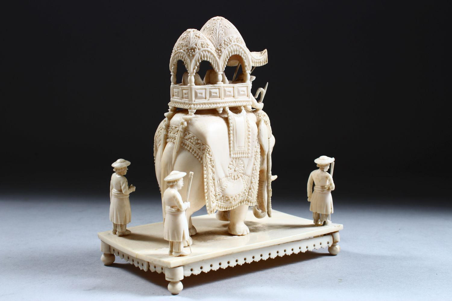 A 19TH CENTURY INDIAN CARVED IVORY FIGURE OF AN ELEPHANT AND ATTENDANTS, in a striding position with - Image 3 of 9