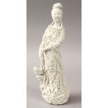 A 20TH CENTURY CHINESE BLANC DE CHINE FIGURE OF GUANYIN, stood holding floral display, 24cm high.