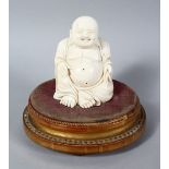 A 19TH CENTURY CHINESE CARVED IVORY BUDDHA ON STAND, the buddha seated upon a later french wooden