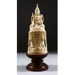 A 19TH CENTURY BURMESE CARVED IVORY GROUP, of a seated god on pierced pedestal also carved with