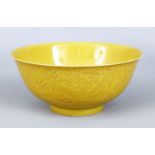 A GOO CHINESE YELLOW GROUND PORCELAIN DRAGON BOWL, the body of the bowl with carved decoration of