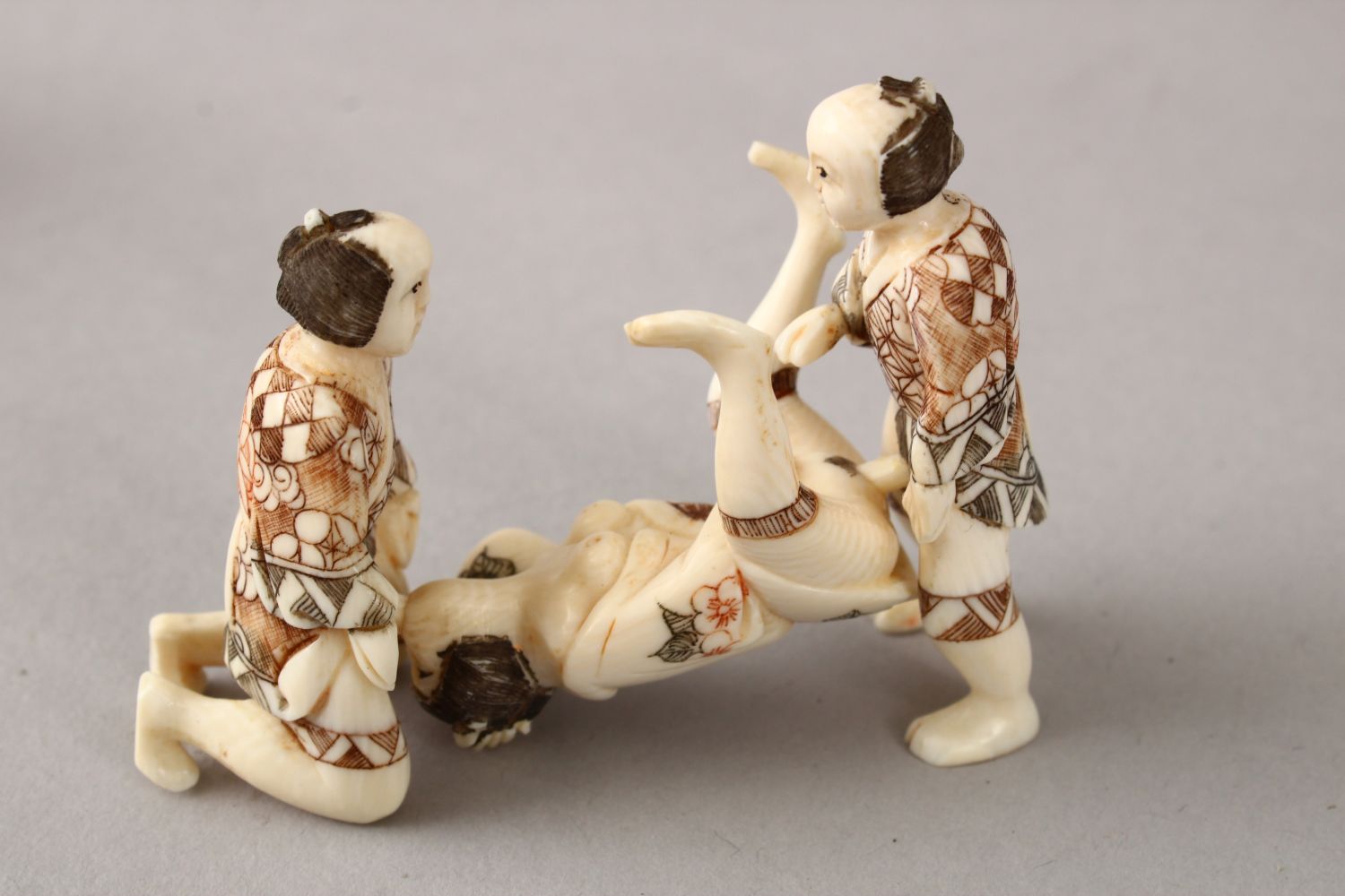 A JAPANESE LATE MEIJI PERIOD CARVED EROTIC IVORY NETUSKE & EROTIC TRIO, the netsuke of a lady over a - Image 3 of 7