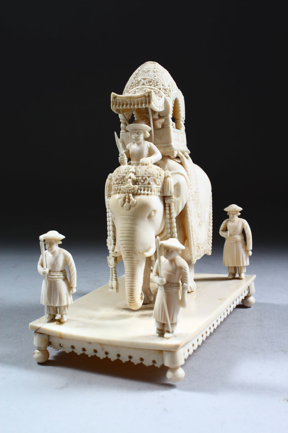 A 19TH CENTURY INDIAN CARVED IVORY FIGURE OF AN ELEPHANT AND ATTENDANTS, in a striding position with - Image 5 of 9