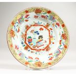 A PAIR OF CHINESE BLUE GROUND PORCELAIN BOWLS, each decorated with birds perched on blossoming