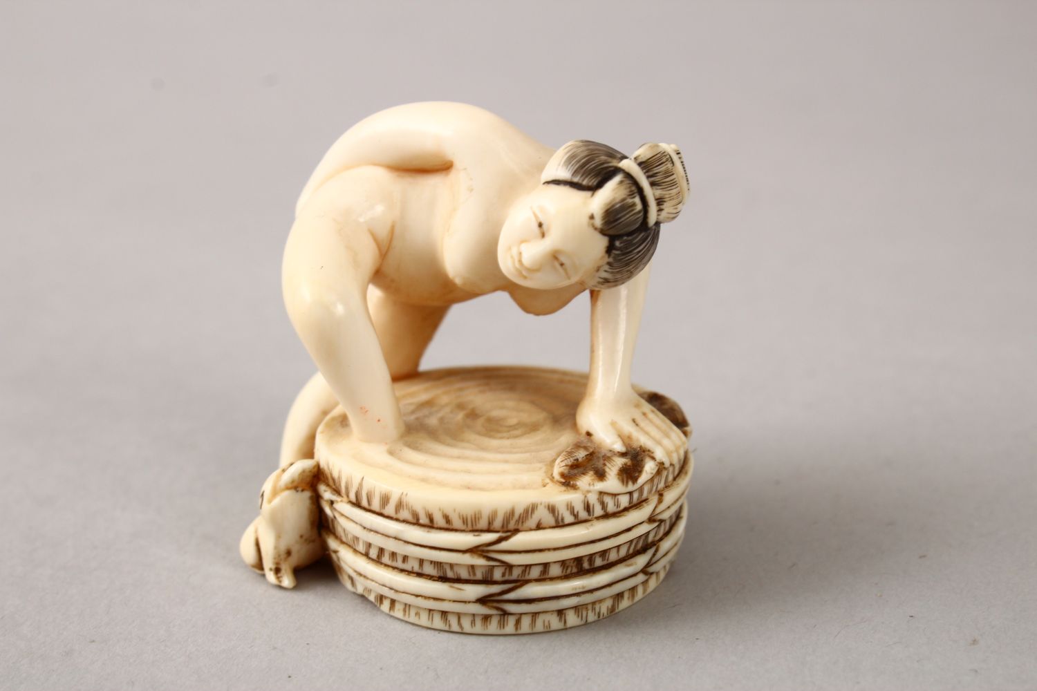 A JAPANESE LATE MEIJI PERIOD CARVED EROTIC IVORY NETUSKE & EROTIC TRIO, the netsuke of a lady over a - Image 5 of 7