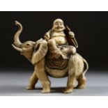 A GOOD JAPANESE MEIJI PERIOD CARVED IVORY OKIMONO OF HOTEI UPON ELEPHANT, the lucky god / buddha