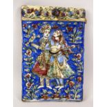A GOOD ISLAMIC PERSIAN QAJAR MOULDED POTTERY TILE, the tile depicting a couple in a flowering