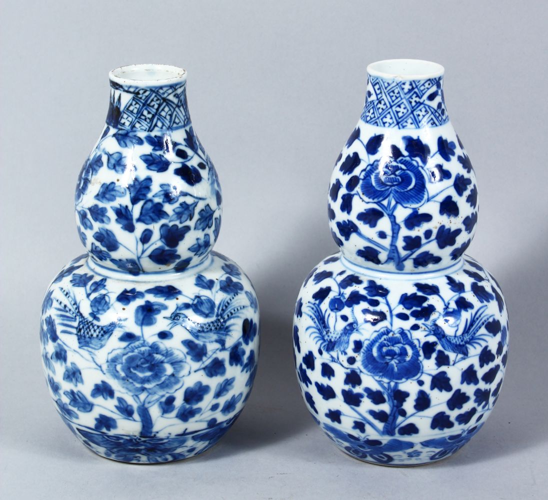 TWO CHINESE 19TH CENTURY BLUE & WHITE DOUBLE GOURD VASES, both painted with typical scenes of