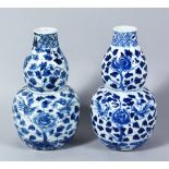 TWO CHINESE 19TH CENTURY BLUE & WHITE DOUBLE GOURD VASES, both painted with typical scenes of