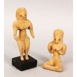 TWO ISLAMIC TERRACOTTA AFGHANISTAN CERAMIC FIGURES, one with stand, one 13.5cm high, the other 9cm