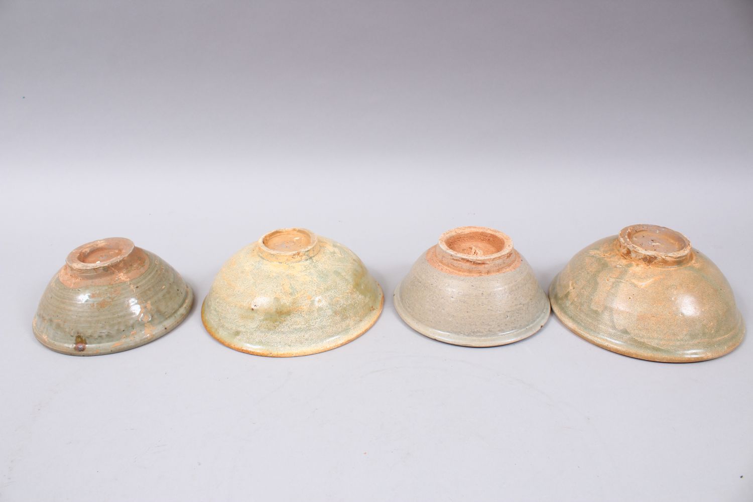 FOUR EARLY CHINESE POTTERY GLAZED BOWLS, some glazed, some partially glazed, various sized but - Image 2 of 2