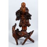 A LARGE 19TH CENTURY CHINESE ROOTWOOD FIGURE OF SHOU LAO, stood upon a naturalistic formed base