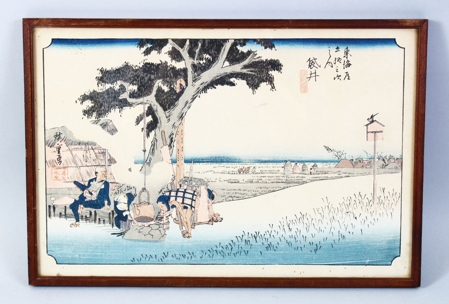 A JAPANESE MEIJI PERIOD WOODBLOCK PRINT OF A LANDSCAPE, framed, signed, 26cm x 38cm