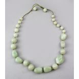 A GOOD QUALITY CHINESE CELADON JADE NECKLACE, Approx 60cm total.