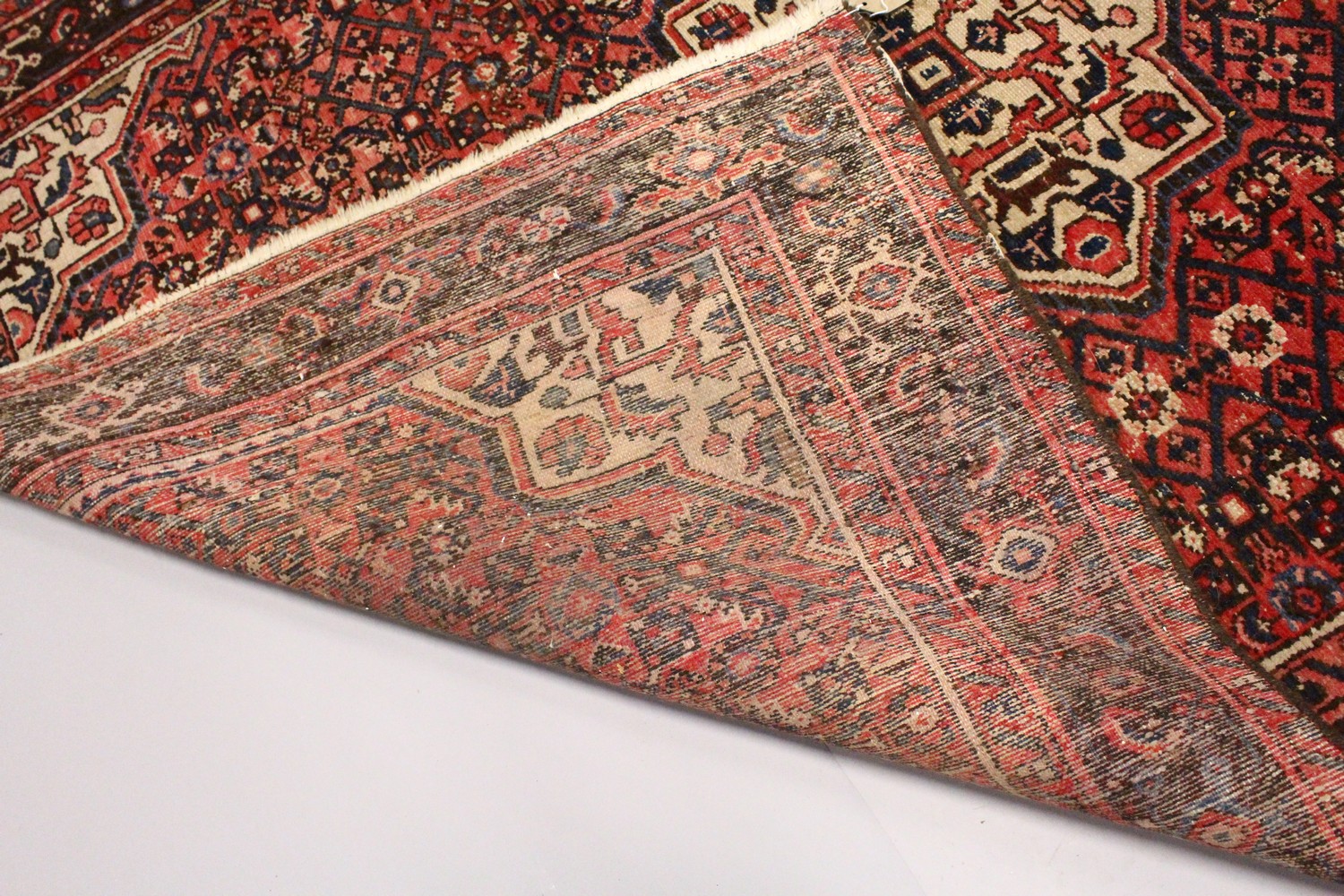 A PERSIAN RUG, 20TH CENTURY, red ground with central medallion, within a dark blue border. 6ft 10ins - Image 8 of 9