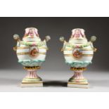 A PAIR OF MEISSEN TWO-HANDLED URN SHAPED VASE, with garlands, masks and ovals of cupids. 7.5ins