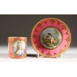 A FINE 19TH CENTURY SEVRES CUP AND SAUCER, rose pompadour ground painted with a cupid with a bird