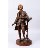 A SUPERB BRONZE OF MOZART, standing beside a lectern, on a circular base. Signed MOZART. 18ins