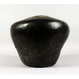 A LARGE EARTHENWARE VASE, possibly African, of bulbous form with dark slip glaze. 12ins wide.
