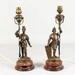 A GOOD PAIR OF BRONZE SOLDIERS, on circular marble bases, converted to electricity. 13ins high.