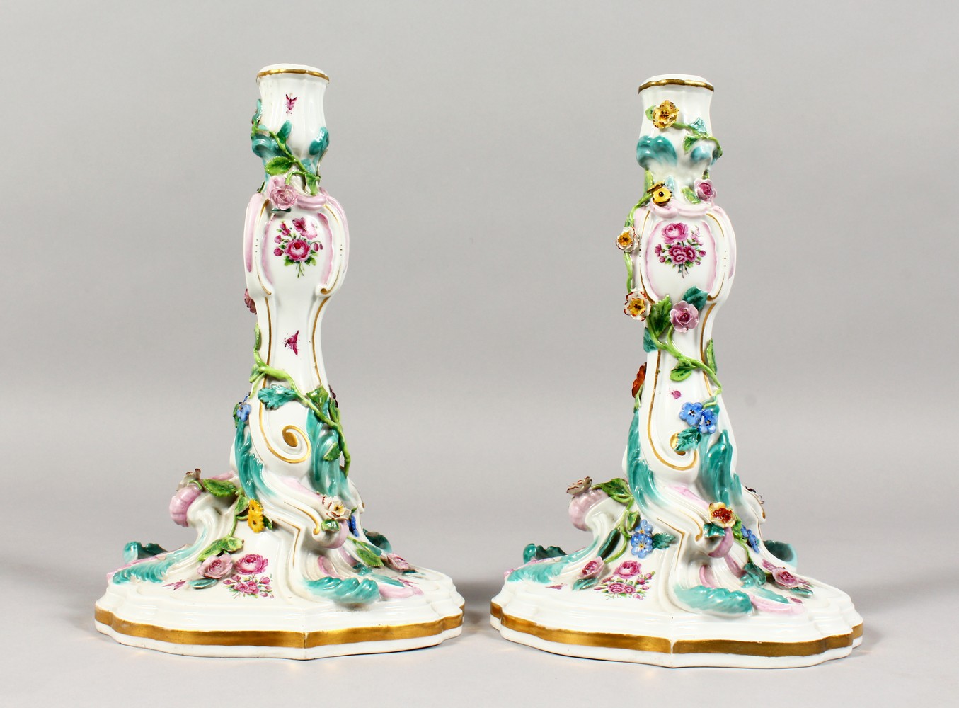 A GOOD PAIR OF 19TH CENTURY MEISSEN CANDLESTICKS, with scrolls, painted and encrusted with flowers