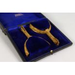 A PAIR OF ORMOLU STIRRUPS, in a fitted box, labelled MAXWELL, 8 DOVER ST., PICCADILLY, W.