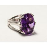 A LARGE SILVER REAL AMETHYST RING.