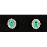 A PAIR OF 18CT WHITE GOLD, EMERALD AND DIAMOND STUD EARRINGS.