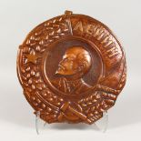 A CIRCULAR EMBOSSED COPPER PLAQUE, depicting Lenin. 15ins diameter.