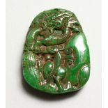 A SMALL CARVED JADE PENDANT. 2ins high.