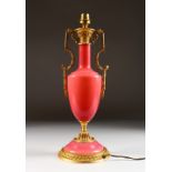 A PINK GLASS TWO-HANDLED URN SHAPED LAMP. 16ins long.