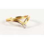 AN 18CT GOLD DIAMOND WISHBONE RING.