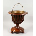 A DUTCH MAHOGANY JARDINIERE, with brass liner and slatted sides. 16ins high.