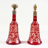 A PAIR OF BOHEMIAN RUBY ENGRAVED SCENT BOTTLES AND STOPPERS, with silver bands.