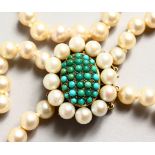 A GOOD TWO-ROW PEARL NECKLACE with turquoise, pearl and gold clasp.