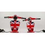 A PAIR OF RED PAINTED METAL LAMP BASES, modelled as the front end of a Vespa scooter. 13ins high x