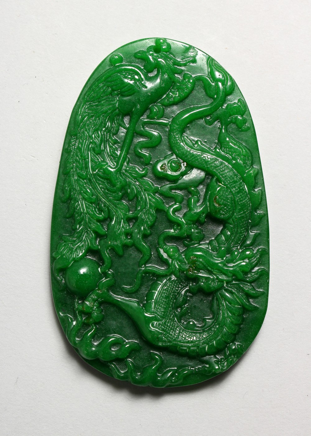 A LARGE CARVED APPLE GREEN JADE PENDANT. 3.75ins high.