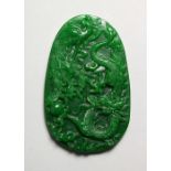 A LARGE CARVED APPLE GREEN JADE PENDANT. 3.75ins high.