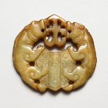 A CARVED JADE PIERCED ROUNDEL.