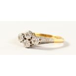 AN 18CT GOLD FOUR STONE CLOVER RING.